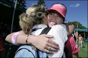 First-time Farr champion Paula Creamer gets a hug from her mother, Karen Creamer, after yesterday's victory. Winning this event was important to the LPGA Tour's Pink Panther.
