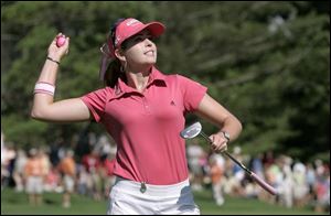 Paula Creamer tosses her pink golf ball into the crowd after capping her victory in the Farr Classic with a par on No. 18 yesterday at Highland Meadows. 