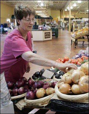 Judy Koles checks out organic vegetables at Claudia's Natural Food Market in Sylvania.
