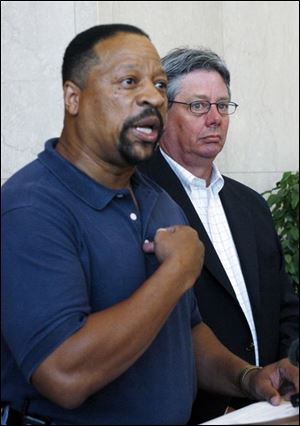 Ray Wood, left, president of UAW Local 14, stands with Lucas County Commissioner Pete Gerken to call on the Lucas County Juvenile Court judge to recognize the union as bargaining agent for its employees. 