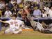 Minnesota Twins' Justin Morneau (33), of the American League team, and Atlanta Braves' Brian McCann, of the National League team, react after Morneau scored the winning run on a sacrifice fly by Texas Rangers' Michael Young in the 15th inning in the Major League Baseball All-Star Game at Yankee Stadium in New York on Wednesday.