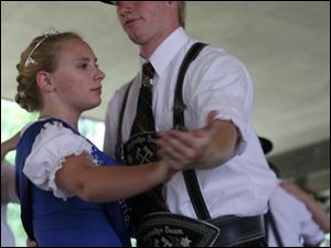 Slug:  NBRE picnic17p           Date: 7/13/2008             The Blade/Amy E. Voigt       Location:Oregon, Ohio  CAPTION:  Holzacher Baum of Toledo members Bryan Pfouts (cq), right, from Walbridge, and Miss Bavarian Sports Club Kristina Strause, left from Toledo, perform a traditional Bavarian folk dance during the Bavarian Sports Club picnic on July 13, 2008 in Oregon. The event offered German bands, food, refreshments, and a soccer tournament.