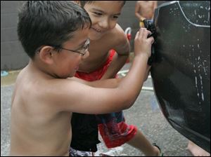 NBRS carwash17p   Kaleb (cq) Serrato, 5, left, of Waterville, and Trey (cq) Chasteen, 6, of Toledo, work on a spot on the back of a Chevy. The Owens Community College child care center holds a fundraising car wash at the college on July 8, 2008. The children will be going on a field trip to Monsoon Lagoon with the money.  The Blade/Jetta Fraser