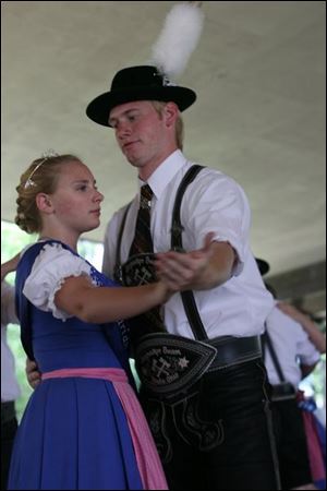 Slug:  NBRE picnic17p           Date: 7/13/2008             The Blade/Amy E. Voigt       Location:Oregon, Ohio  CAPTION:  Holzacher Baum of Toledo members Bryan Pfouts (cq), right, from Walbridge, and Miss Bavarian Sports Club Kristina Strause, left from Toledo, perform a traditional Bavarian folk dance during the Bavarian Sports Club picnic on July 13, 2008 in Oregon. The event offered German bands, food, refreshments, and a soccer tournament.