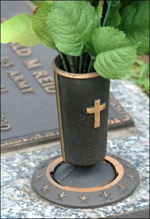 Cemetery ornaments such as this bronze vase are stolen and melted. The metal is sold.
