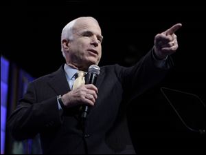 Sen. John McCain addresses the NAACP's annual convention, where he received a polite but not warm reception. Marjorie Mosely has a question about education policy for Senator McCain, who favors taxpayer-funded vouchers to help parents pay for tuition at nonpublic schools.