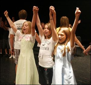 Cast members Emile Cotte, 11, left, Abby Newman, 10, and Anya Kress, 11, deliver a spirited performance at rehearsal. 