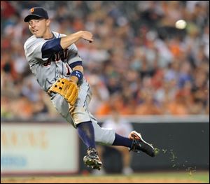 Tigers third baseman Brandon Inge charges, scoops, then throws to first to retire the Orioles' Melvin Mora in the eighth.