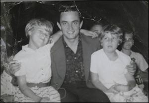 Young Sharon Chinni, right, and her sister, Linda Lutes, with Johnny Cash. 