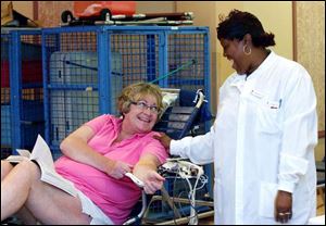 Marsha Ettl, left, of Toledo shares a laugh with Red Cross employee Monica Belcher after giving blood during a drive at the Little Sisters of the Poor in Oregon yesterday. The agency says supplies of some blood types are at a half day or less. 