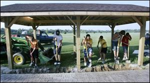 Glandorf teens volunteer their time at a new park shelter.