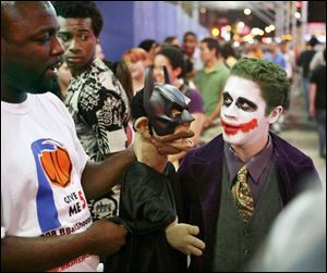 Jose Rivera, right in Joker makeup, and other fans lineup to see The Dark Knight in New York City. The movie had record three-day ticket sales of $155.3 million, surpassing Spider-Man 3. (NEW YORK TIMES)
<br>
<img src=http://www.toledoblade.com/assets/gif/weblink_icon.gif> <b><font color=red>NEW FEATURE</b></font color=red>: <a href=