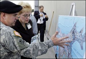 Rep. Marcy Kaptur (D., Toledo) talks with U.S. Army Corps
of Engineers  Col. Alvin Lee as a congressional leaders view
remaining damage left in Harvey, La., by Hurricane Katrina.

