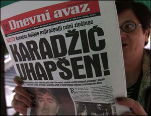 A Bosnian woman reads the Bosnian daily newspaper, headlined 