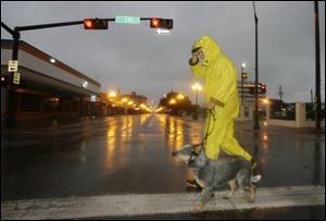 Ren Garcia walks his dog, Buddy, through downtown Brownsville, Texas, as Hurricane Dolly approaches the Rio Grande Valley on Wednesday. (ASSOCIATED PRESS)
<br>
<img src=http://www.toledoblade.com/graphics/icons/video.gif> <b><font color=red>VIDEO</b></font color=red>: <a href=