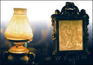 Nineteenth-century German lithophanes mounted in a lamp, left, and a candle shield.