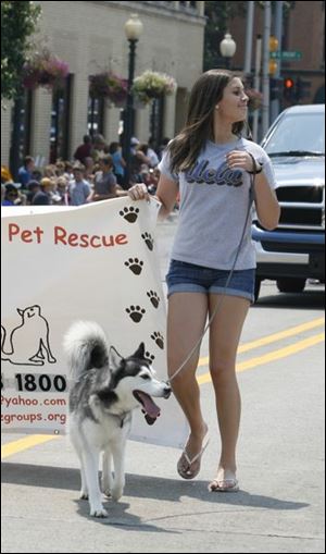 Erin Kelly of Monroe walks with her dog Shasta to promote a pet rescue program.