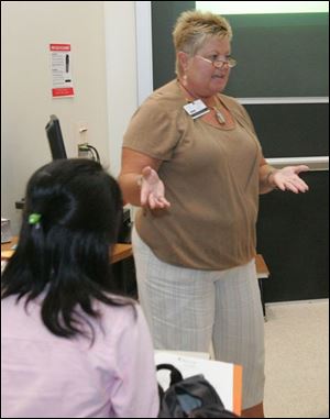 Kim Holman, a registered nurse, speaks to Taiwanese students at Owens on trends in nursing education.