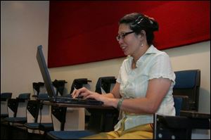 Jieh Chang, an assistant professor in Taiwan, takes notes at Owens Community College.