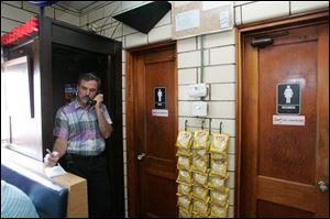 In the original phone booth, Doug Schmucker takes down an order.