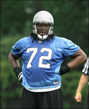 Tackle George Foster gets a break during a Lions practice yesterday at training camp in Allen Park, Mich.