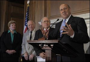 Wisconsin Gov. Jim Doyle, right, talks on Capitol Hill. Other lawmakers are Sen. Debbie Stabenow of Michigan, left, Rep. James Oberstar of Minnesota, and Sen. Carl Levin of Michigan.