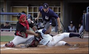 Indianapolis catcher Carlos Maldonado tags out the Mud Hens' Freddy Guzman, who stole four bases last night.