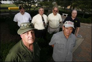 In front, from left, are Gene Shurtz, who served in Vietnam in 1969-70 and Robert Bodi, who served in 1967 and 1968. At rear, from left, are Dick Nolte, in Vietnam 1969-1970; Jerry Eversman, committee chairman; Jim Brower, assistant chairman, and John Eberth, U.S. Army 519th Military Intelligence Battalion, 1967-68, at what will be the site of the Oregon war memorial.