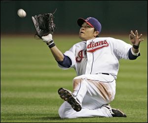 Cleveland Indians right fielder Shin-Soo Choo, from Korea, makes a sliding attempt but can't catch a sinking fly ball by Detroit Tigers' Placido Polanco in the 11th inning Wednesday. Choo did recover to force Curtis Granderson at second base. 