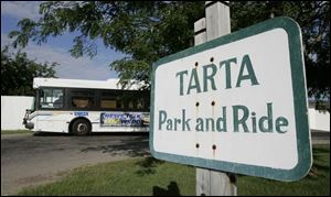 The 2X Sylvania Express picks up passengers at the TARTA station on Centennial Road. The route was proposed for elimination under TARTA's budget cuts, but officials reinstated part of the service and renamed it 2C. Altogether, officials proposed cuts to 19 TARTA routes to cope with rising fuel prices. The service reductions are expected to save about $1 million. 