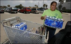 Sherran Thompson stocks up on bottled water in at a supermarket in Galveston, Texas on Monday in preparation for Tropical Storm Edouard. 