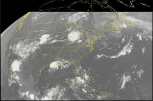 This NOAA satellite image taken Tuesday, Aug. 5, 2008 at 1:15 a.m. EDT shows cloud cover in the Plains and Midwest. Near Chicago these clouds produced a severe weather outbreak Monday that brought damaging winds and hail to the region. Also visible is Tropical Storm Edouard in the Gulf of Mexico. The storm is expected to make landfall Tuesday morning. 