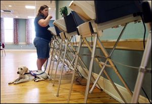 A voter at the Monclova Community Center casts her ballot to decide the fate of two levy requests for Anthony Wayne Schools.
