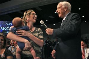 Sara Chongson of Lima, with son Leo, was among those who had questions for Sen. John McCain during yesterday s visit.
