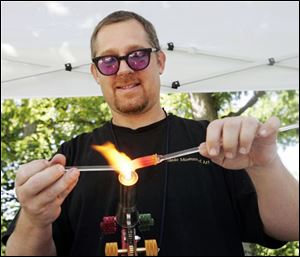 CTY artszoo11p  08/10/ 2008 The Blade/Dave Zapotosky Caption:  Gideon Rockwood, a flame working instructor at the Toledo Museum of Art, makes glass bananas during the Arts Gone Wild Event at the Toledo Zoo, Sunday, August 10, 2008. He was going to make a glass monkey to go along with the glass bananas he was making.  Summary: Arts Gone Wild at the Toledo Zoo.