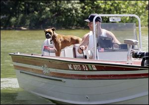 Rob Felts of Coldwater, Mich., and Roxi take a spin on James Lake. Park activities include fishing and swimming.