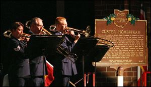 Staff Sgt. Jennett Smithhisler, Senior Master Sgt. Phil Smith, and Staff Sgt. Kurt Dieringer play trombones at the dedication.