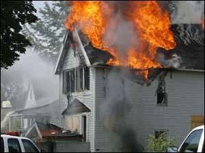 CTY fire12p  Toledo Firefighters contain a fire in an unoccupied two-storey house on Georgia just west of  Upton in Toledo, Ohio on August 12, 2008. According to TFD Lt. Kevin Gordon, the house was not safe to enter, so they were fighting the fire from just the outside, working to keep it from spreading to nearby, also vacant houses.    The Blade/Jetta Fraser