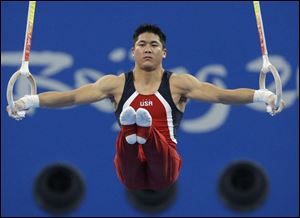 Kevin Tan, an image of focus, executes his routine on the rings during competition yesterday at the Beijing 2008 Olympics.