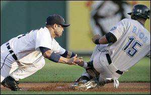 Toronto's Alex Rios, right, beats the tag from Detroit's Placido Polanco to steal second base.