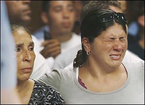 Cindy Dugan, left, and Molly Dugan, mother and sister respectively, of the murdered Matthew Dugan, hear the bailiff call 'Anthony Belton' the alleged shooter, at the arraignment Friday.
