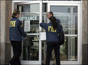 FBI agents enter the City-County Building in downtown Cleveland, Monday, July 28, 2008. Cuyahoga County's top elected official, Commissioner Peter Lawson Jones, has pledged cooperation with a federal investigation into alleged public corruption in Ohio's most populous county.