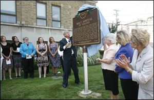  A marker notes the 90th anniversary of Mercy Hospital and the Mercy School of Nursing.