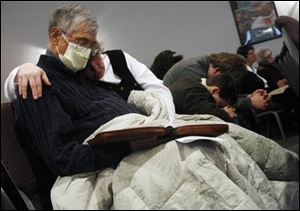 Mr. Steele and his wife, Pam, pray during a Christmas service at a Port Clinton church.