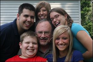 Jim Lefevre, center, is surrounded by his grandchildren, clockwise from bottom left: Troy Lefevre, Jared Lefevre, Caitlin
Lefevre, Jamie Lefevre, and Emily Mitchell. The grandchildren call him  Grandpa Fuzzy  or simply  Fuzzy  because of his beard.