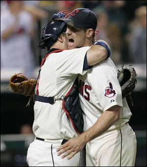 Cliff Lee gets a hug from his catcher, Kelly Shoppach, after the Indians' left-hander won his 20th game by shutting out the White Sox on five hits. He is now 20-2 on the season.