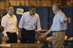 Democratic presidential hopeful Barack Obama, center, tours a York, Pa., hydro-turbine manufacturing facility.