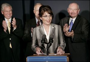 Alaska Gov. Sarah Palin, center, is applauded by fellow Republican governors Don Carcieri, left, of Rhode Island; Jim Douglas of Vermont, behind her, and Sonny Perdue of Georgia.