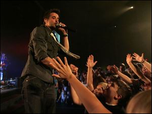 Slug:  REL Sanctus06p       Date:   09/04/2008       The Blade/Andy Morrison       Location: Toledo       Caption: Sanctus Real lead singer Matt Hammitt works the crowd during a concert at CedarCreek Church, Thursday, 09/04/2008.        Band members are Matt Hammitt, lead vocals; Chris Rohman, guitar (curly black hair); Mark Graalman, drums; Dan Gartley, bass, and Pete Prevost, guitar. Concert starts at 7 but there are 2 opening bands; 8 pm is approx start time for Sanctus Real.