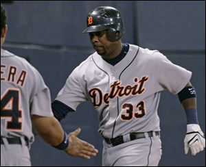 Tigers outfielder Marcus Thames is greeted at the dugout after hitting a solo homer in the fifth frame of a 10-2 loss to the Twins.